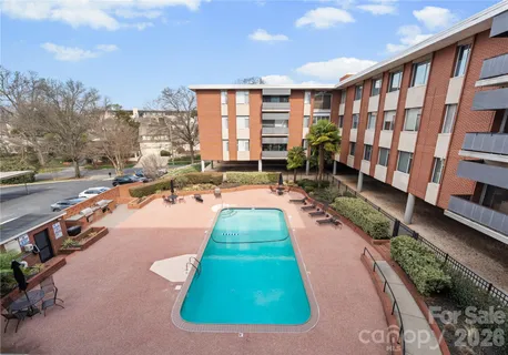 a view of a house with swimming pool and sitting area