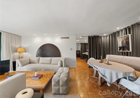 a living room with furniture and a lamp