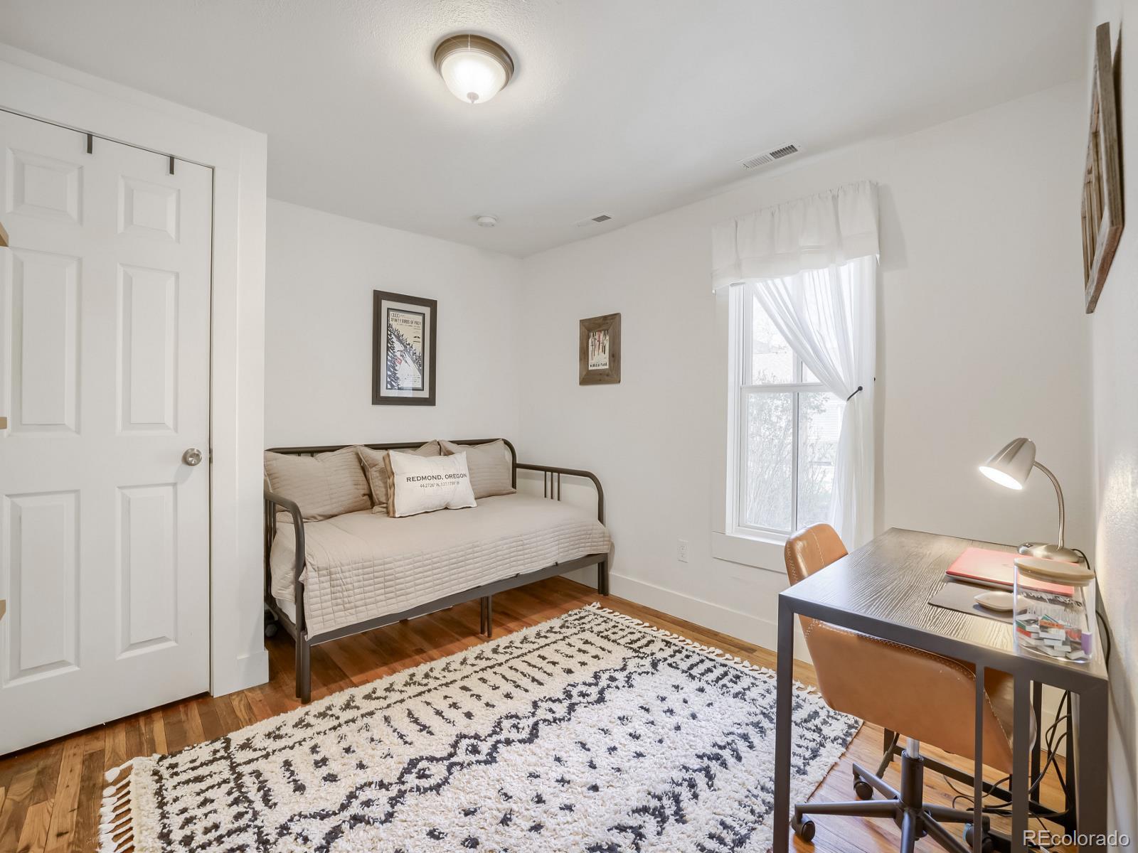 407 Seventh Street Georgetown, CO 80444 - Photo 18 of 28 a bedroom with furniture and a window
