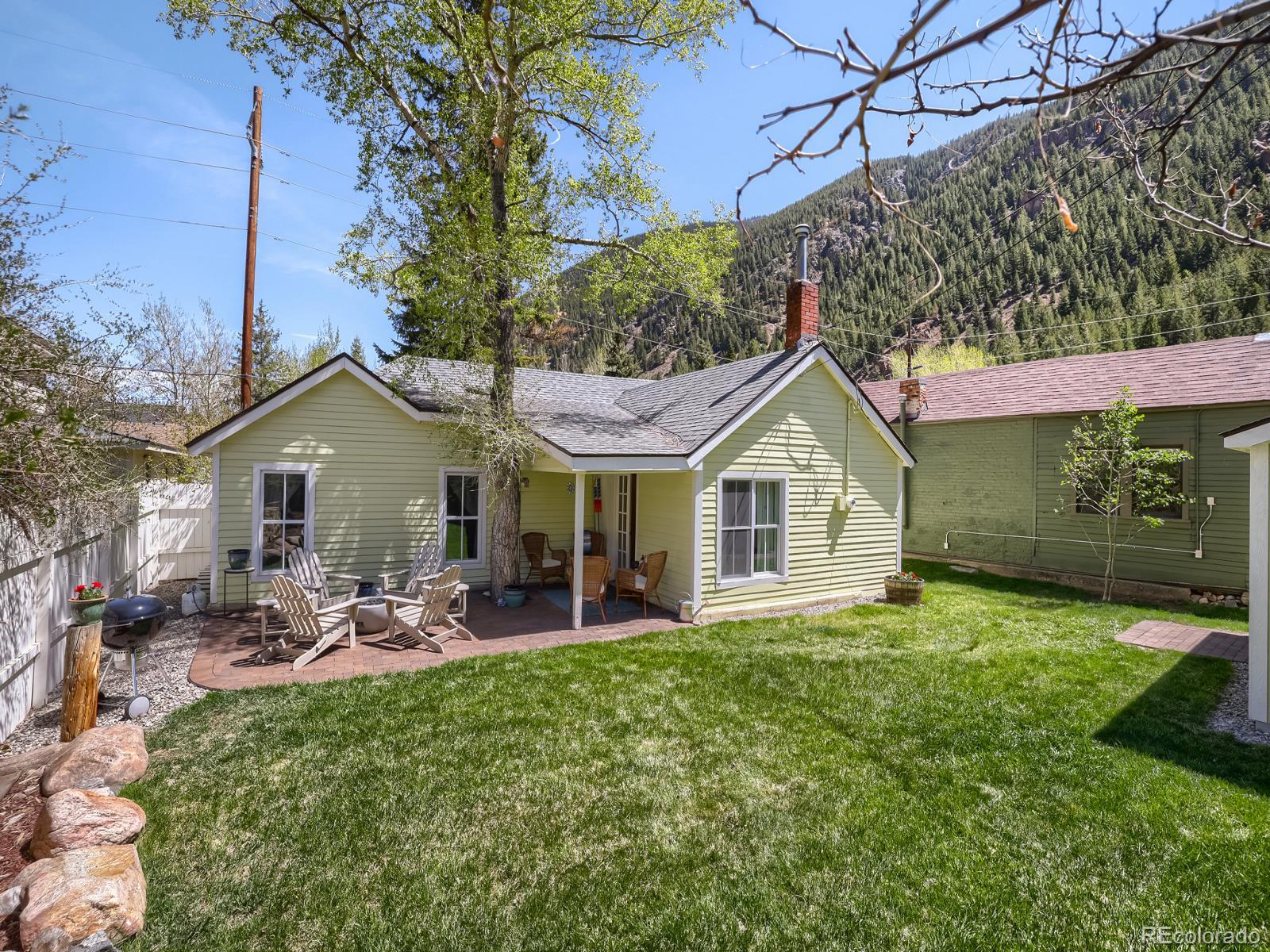 407 Seventh Street Georgetown, CO 80444 - Photo 20 of 28 a front view of a house with a yard and garage