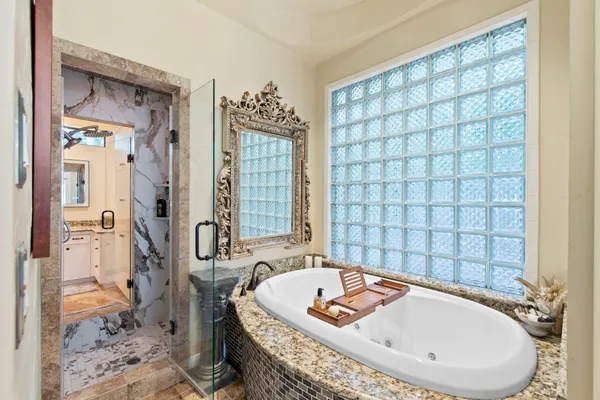 a bath tub sitting in a bathroom next to a window