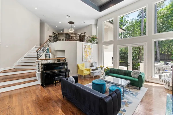 a living room with furniture and a piano