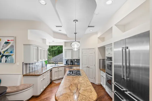 a large white kitchen with a large window
