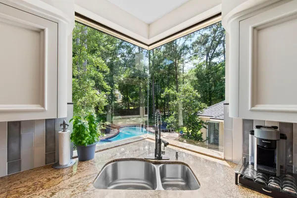a kitchen with a sink and a large window