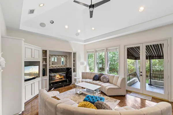 a living room with furniture large window and a fireplace
