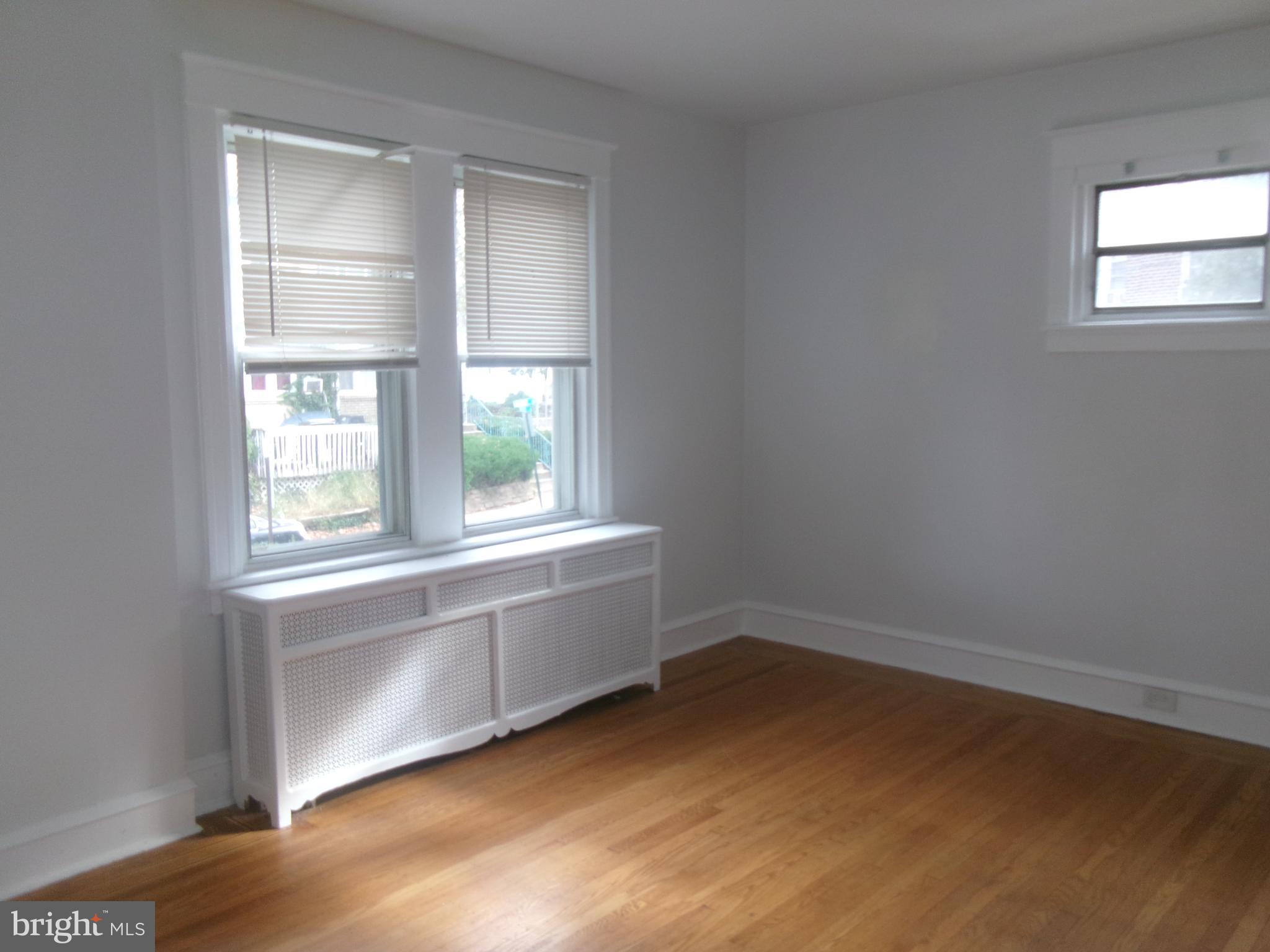 200 Wembly Road Upper Darby, PA 19082 - Photo 15 of 47 an empty room with wooden floor and windows