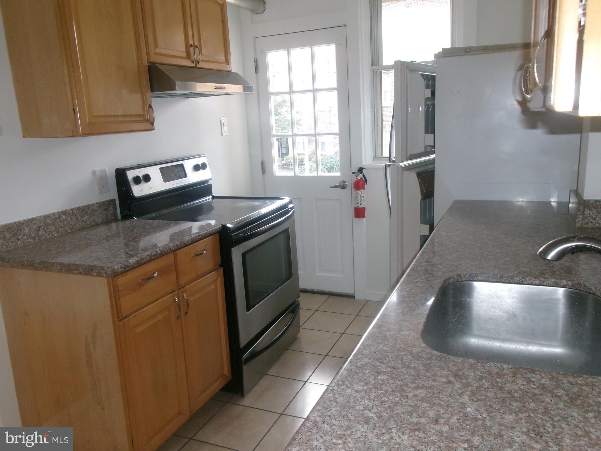 200 Wembly Road Upper Darby, PA 19082 - Photo 20 of 47 a kitchen with stainless steel appliances granite countertop a sink stove and refrigerator