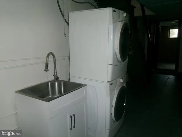 a kitchen with a refrigerator and washer