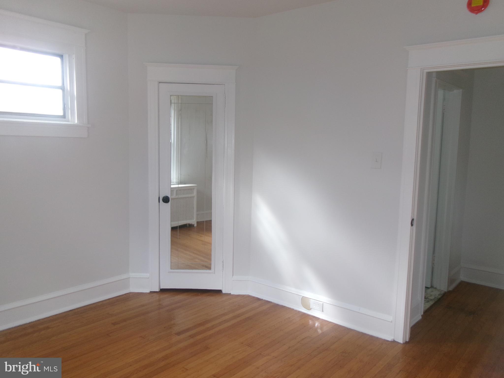 200 Wembly Road Upper Darby, PA 19082 - Photo 36 of 47 an empty room with wooden floor and windows