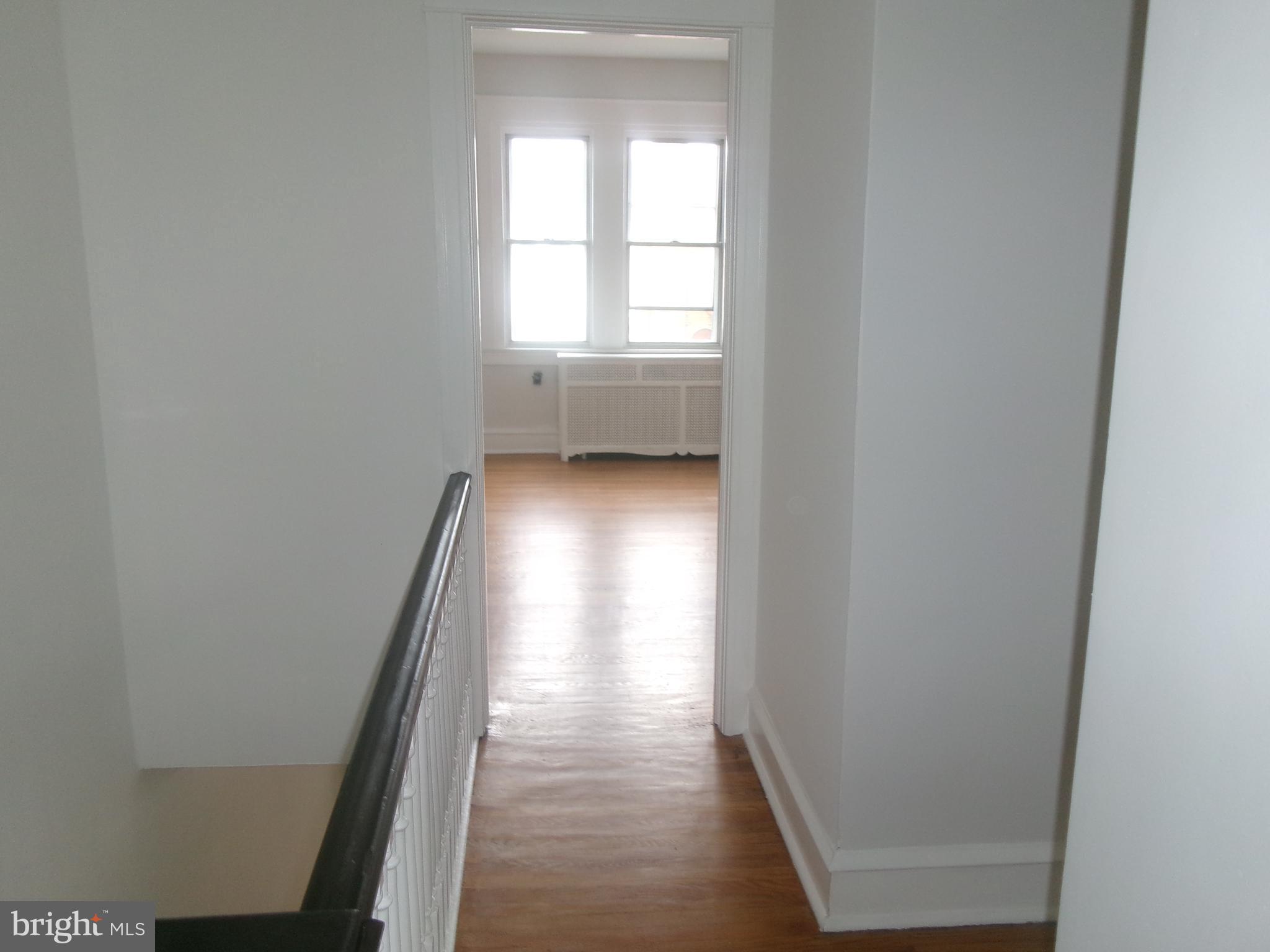 200 Wembly Road Upper Darby, PA 19082 - Photo 37 of 47 an empty room with wooden floor and windows