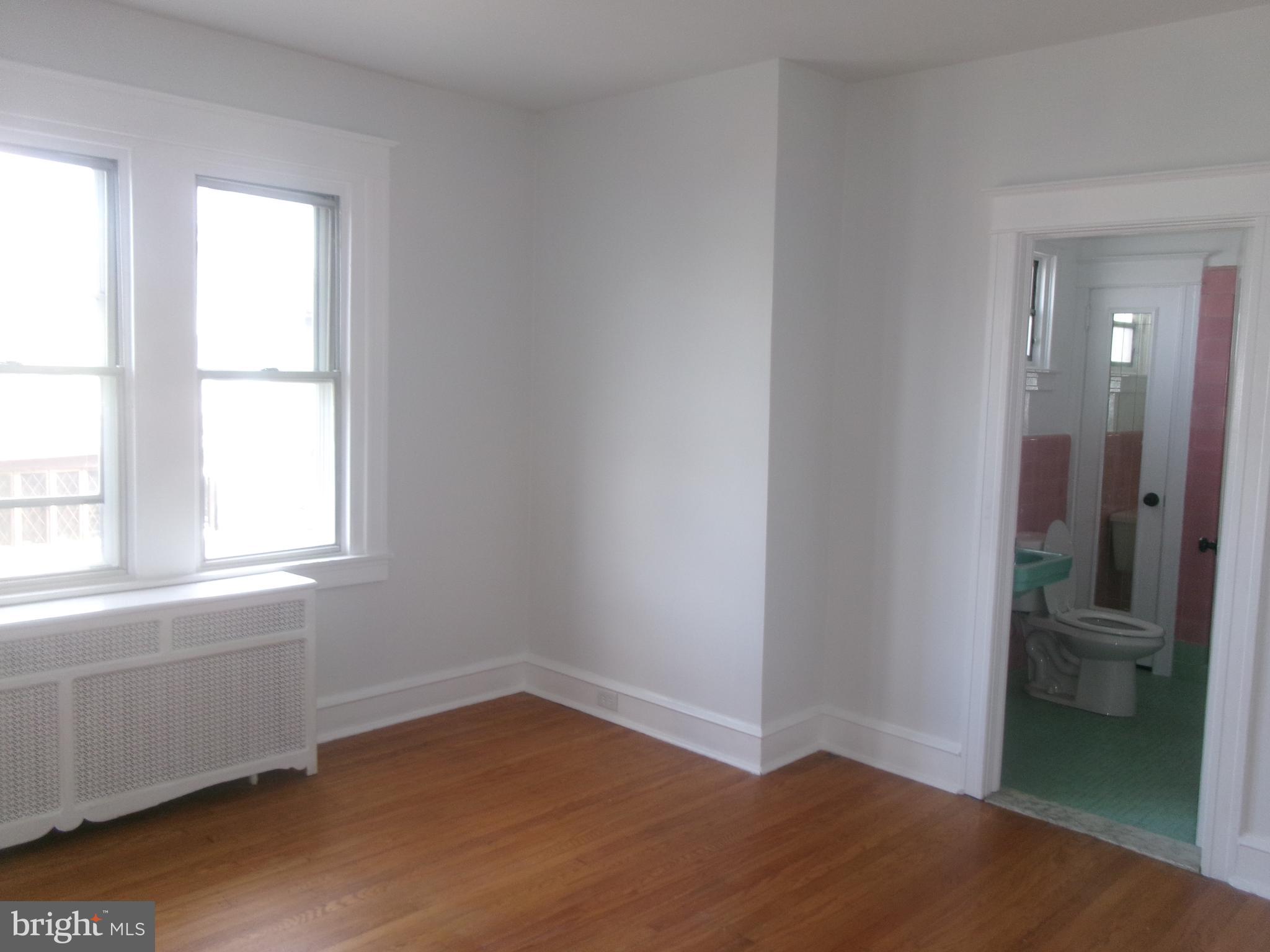 200 Wembly Road Upper Darby, PA 19082 - Photo 38 of 47 an empty room with wooden floor and a window