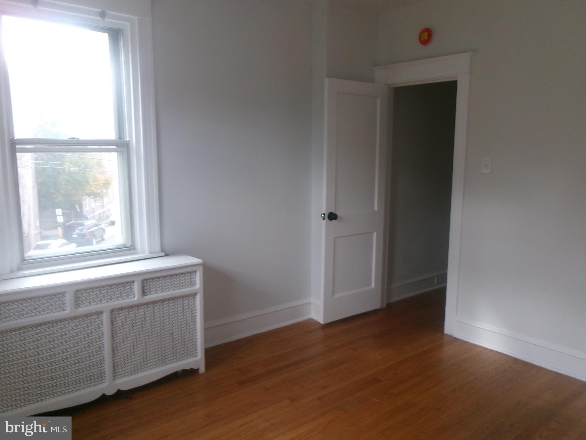 200 Wembly Road Upper Darby, PA 19082 - Photo 46 of 47 an empty room with wooden floor and windows