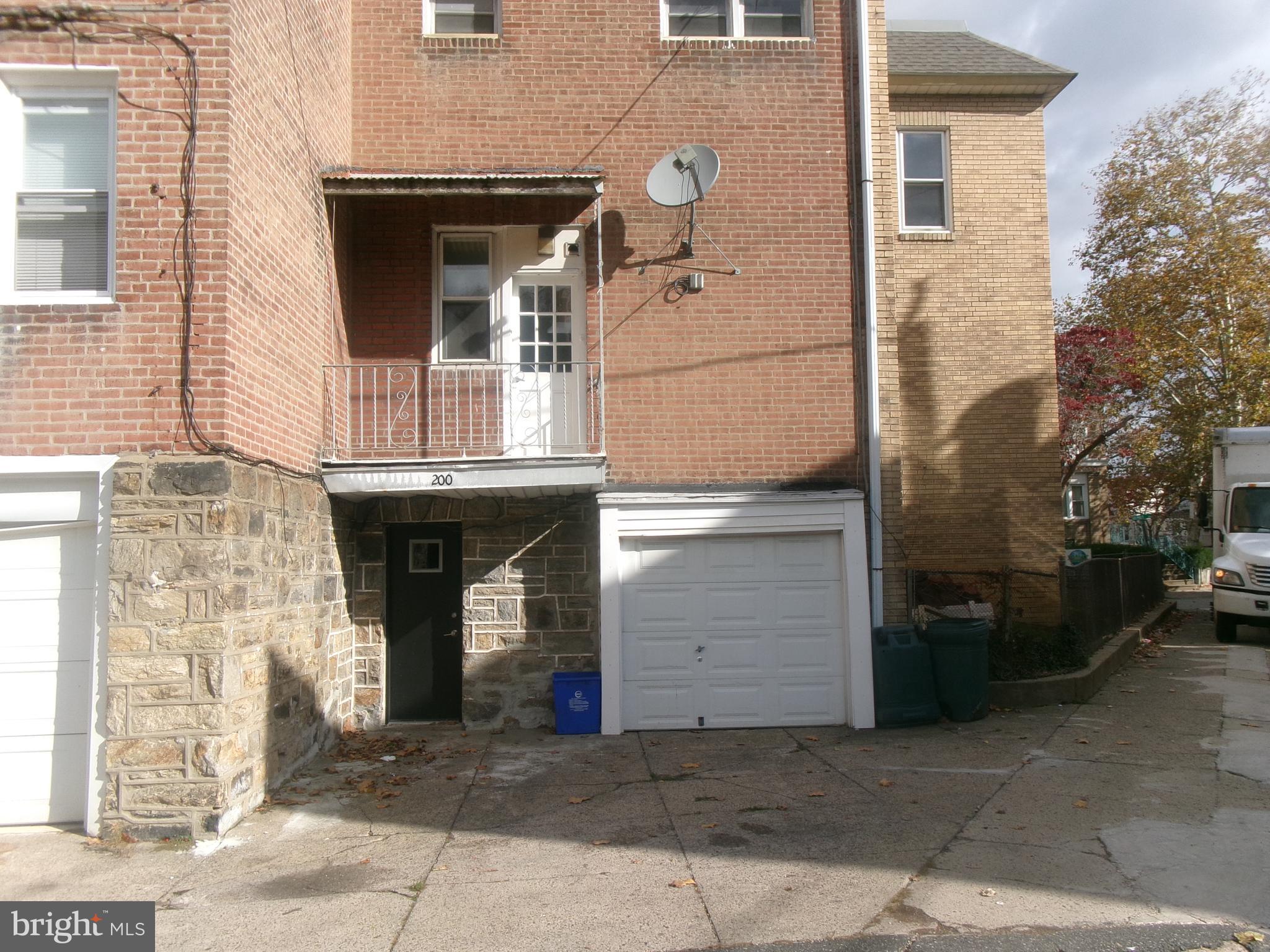 200 Wembly Road Upper Darby, PA 19082 - Photo 5 of 47 a front view of a house with a garage