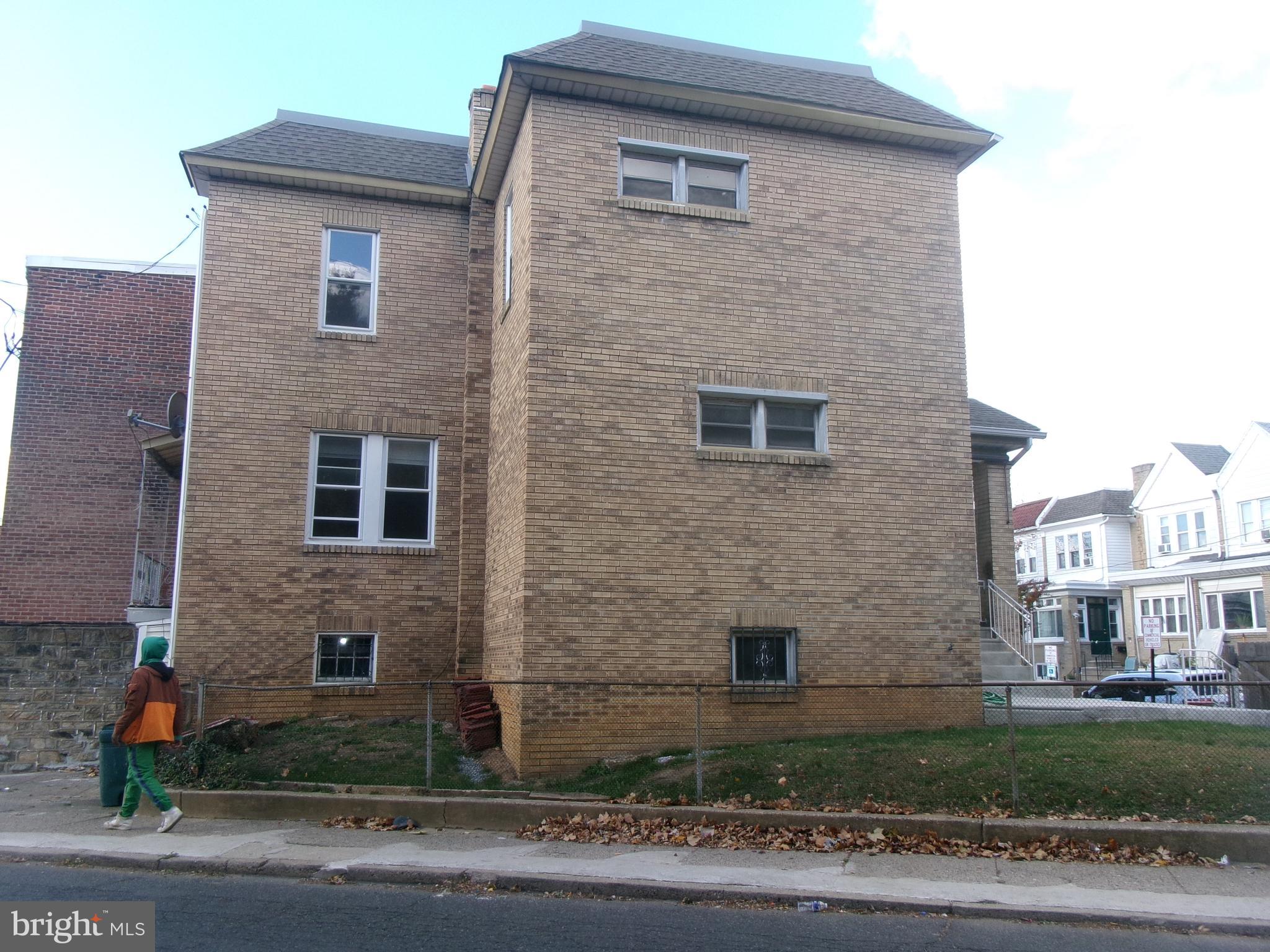 200 Wembly Road Upper Darby, PA 19082 - Photo 8 of 47 a brick house with a yard and windows