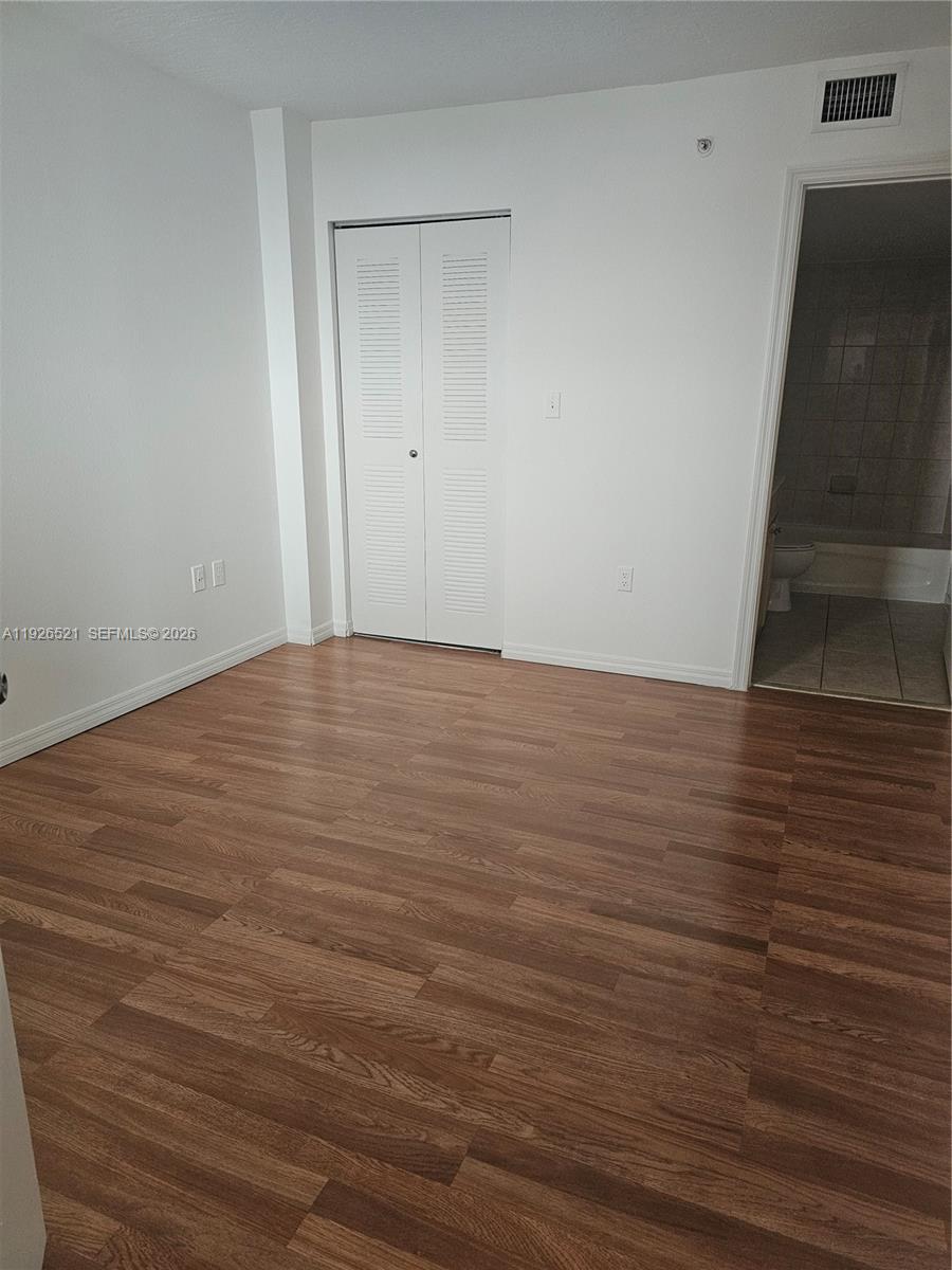 102 Southwest 6th Avenue, Unit 604 Miami, FL 33130 - Photo 11 of 13 a view of an empty room with wooden floor