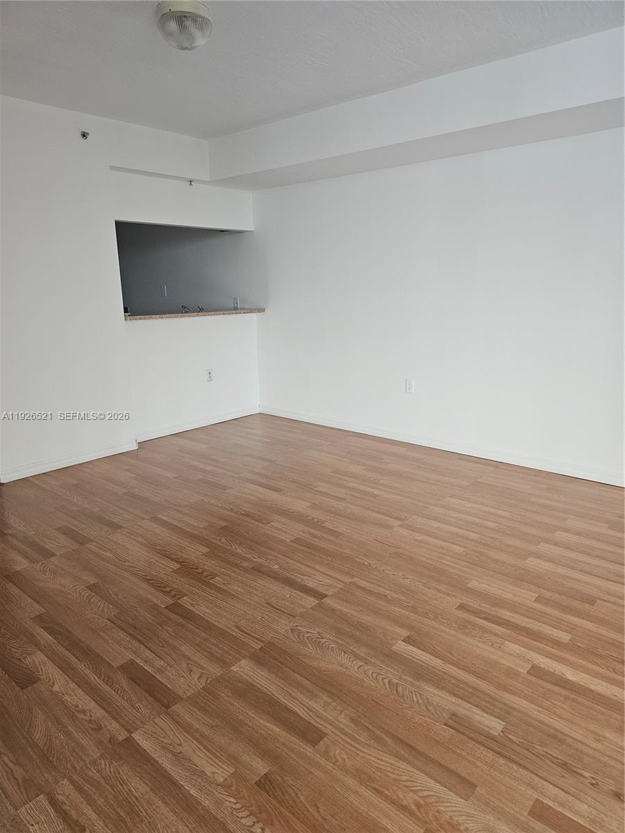 102 Southwest 6th Avenue, Unit 604 Miami, FL 33130 - Photo 12 of 13 a view of empty room with wooden floor