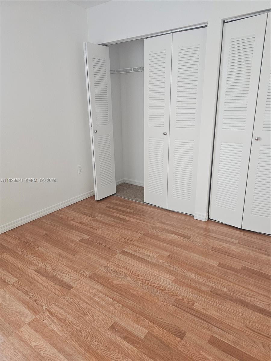 102 Southwest 6th Avenue, Unit 604 Miami, FL 33130 - Photo 8 of 13 a view of empty room with wooden floor
