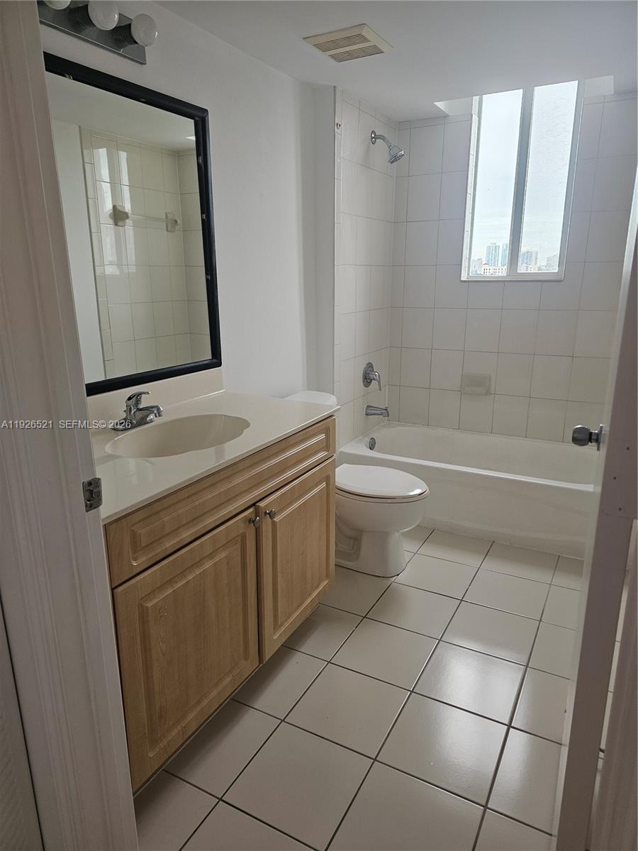 102 Southwest 6th Avenue, Unit 604 Miami, FL 33130 - Photo 9 of 13 a bathroom with a sink a toilet and mirror