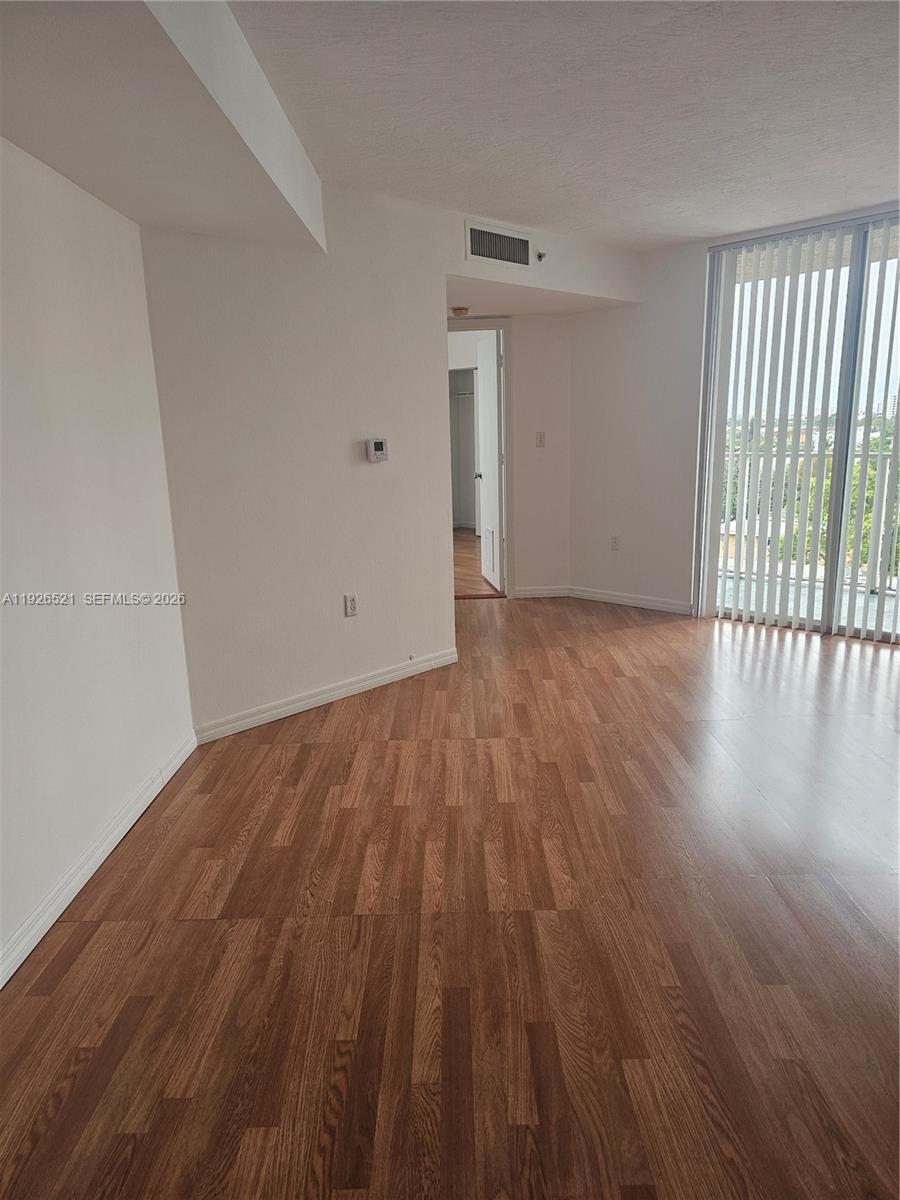 102 Southwest 6th Avenue, Unit 604 Miami, FL 33130 - Photo 10 of 13 an empty room with wooden floor and windows
