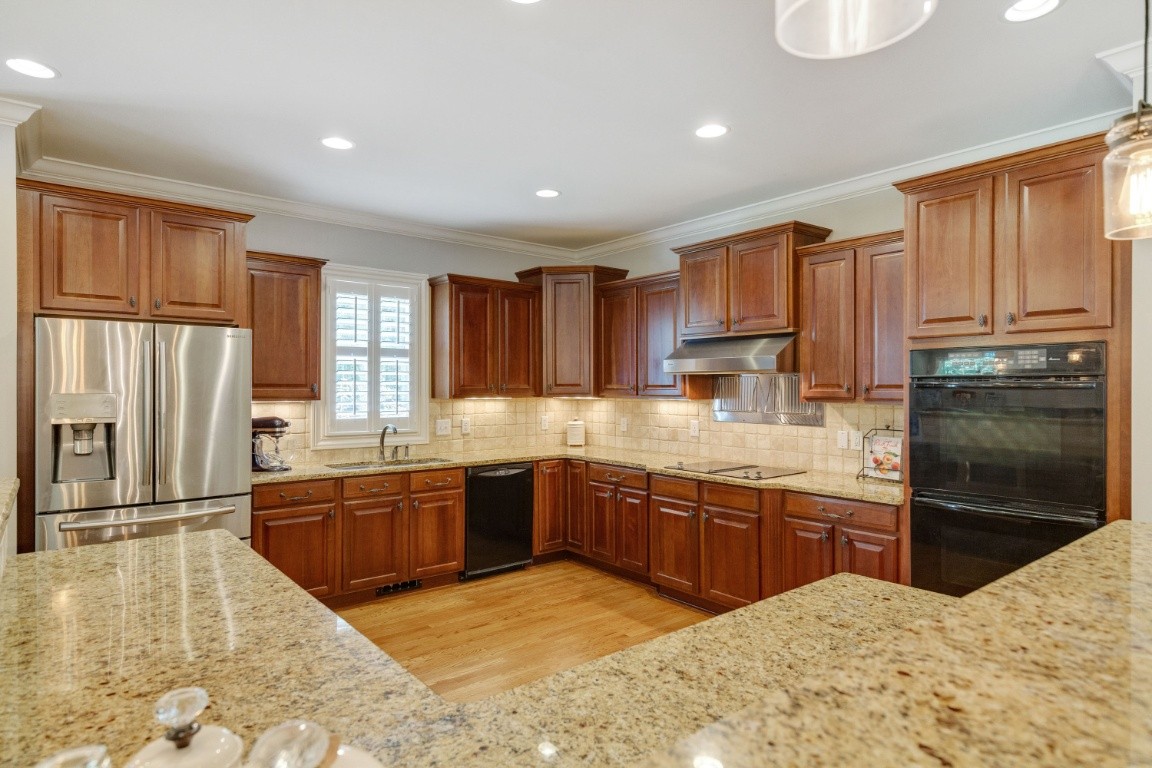 5660 Pinewood Road Franklin, TN 37064 - Photo 13 of 45 a large kitchen with granite countertop a large counter top stainless steel appliances a sink cabinets and a window