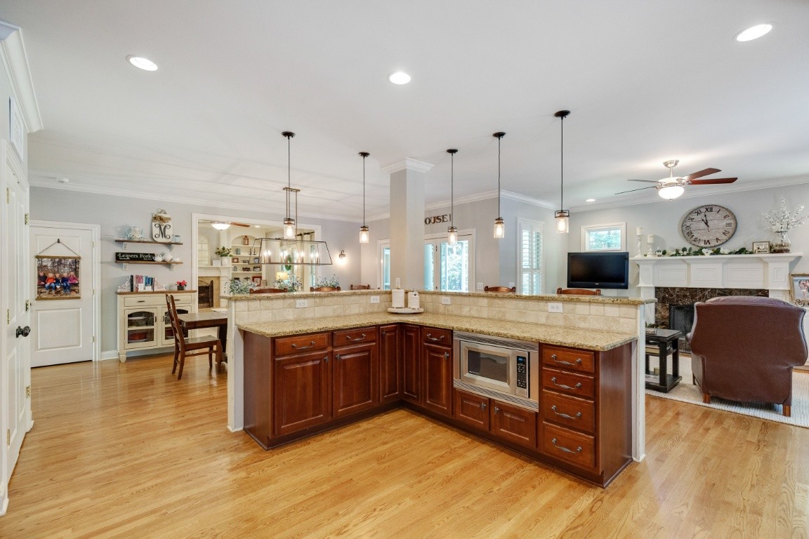 5660 Pinewood Road Franklin, TN 37064 - Photo 14 of 45 a large kitchen with stainless steel appliances granite countertop a stove and cabinets with wooden floor