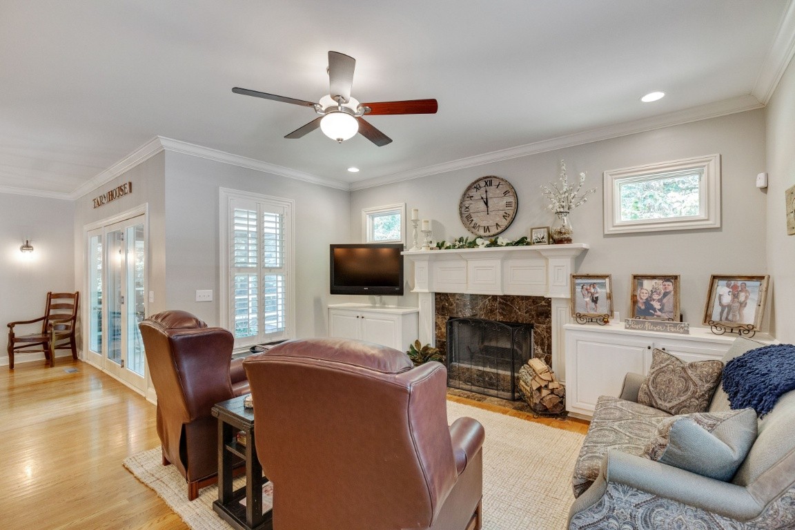 5660 Pinewood Road Franklin, TN 37064 - Photo 16 of 45 a living room with furniture a fireplace and a flat screen tv