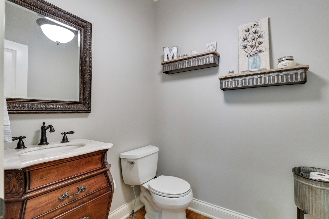 5660 Pinewood Road Franklin, TN 37064 - Photo 22 of 45 a bathroom with a toilet a sink and mirror