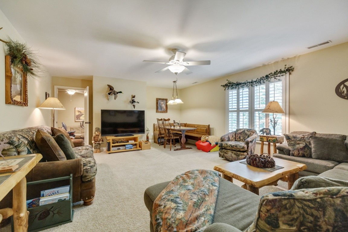 5660 Pinewood Road Franklin, TN 37064 - Photo 26 of 45 a living room with furniture a flat screen tv and kitchen view