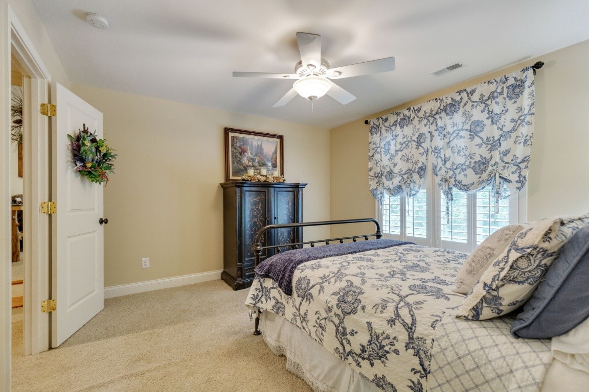 5660 Pinewood Road Franklin, TN 37064 - Photo 29 of 45 a bedroom with a bed and a chandelier