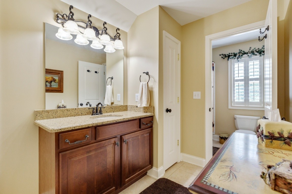 5660 Pinewood Road Franklin, TN 37064 - Photo 31 of 45 a spacious bathroom with a granite countertop sink a large mirror and a shower