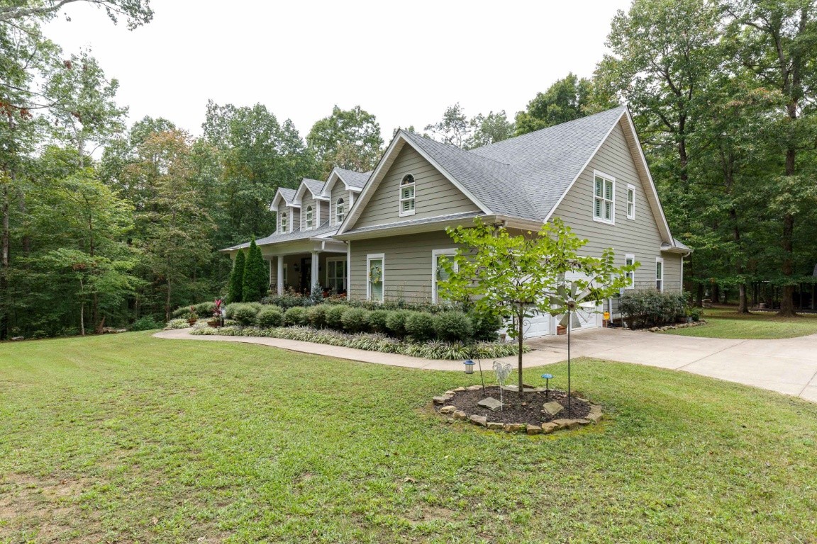 5660 Pinewood Road Franklin, TN 37064 - Photo 45 of 45 a front view of a house with a yard garage and fountain