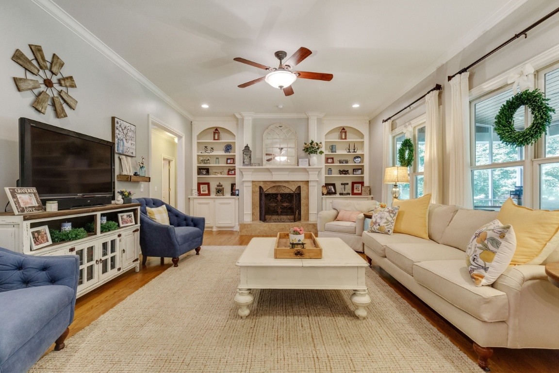 5660 Pinewood Road Franklin, TN 37064 - Photo 7 of 45 a living room with furniture a flat screen tv and a fireplace