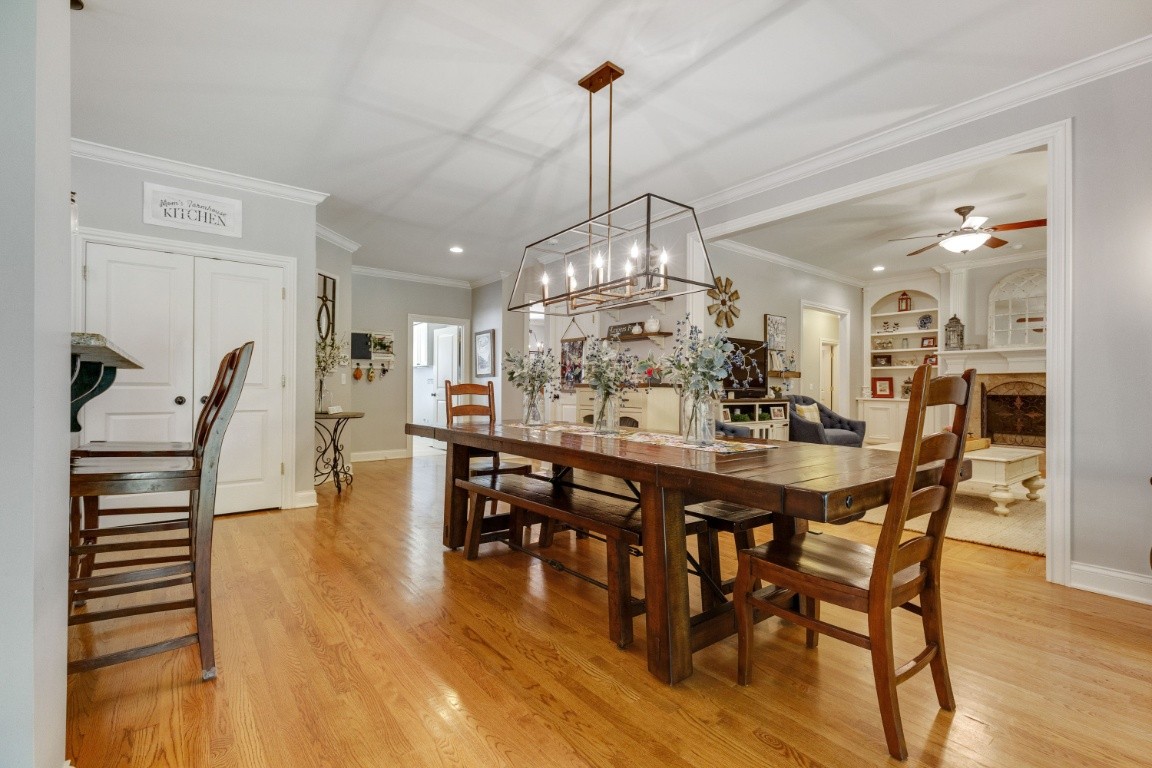 5660 Pinewood Road Franklin, TN 37064 - Photo 9 of 45 a view of a dining room and livingroom with furniture wooden floor a chandelier
