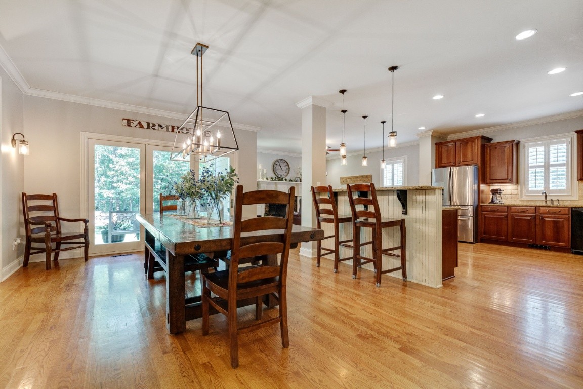 5660 Pinewood Road Franklin, TN 37064 - Photo 10 of 45 a view of a dining room and livingroom with furniture wooden floor a chandelier
