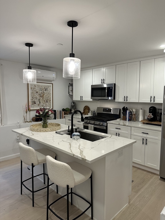 24 Ferrin Street, Unit 2 Boston, MA 02129 - Photo 2 of 9 a kitchen with appliances a sink and a center island
