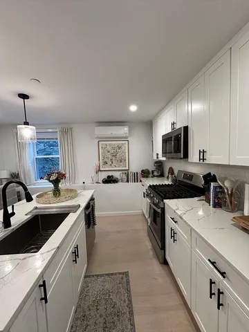 a kitchen with a sink stove and cabinets