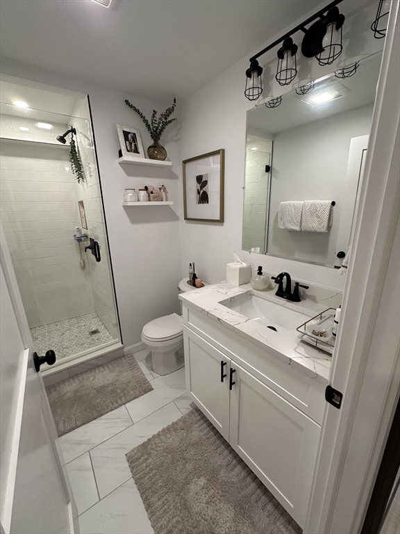 24 Ferrin Street, Unit 2 Boston, MA 02129 - Photo 5 of 9 a bathroom with a sink a toilet a mirror and shower