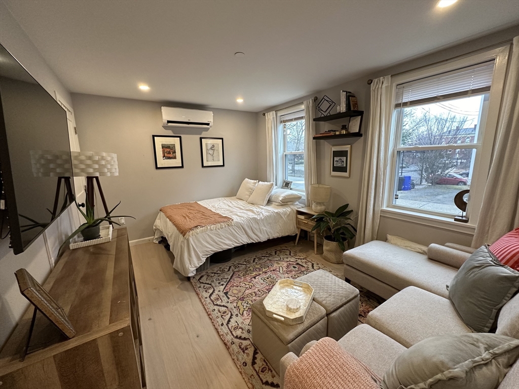 24 Ferrin Street, Unit 2 Boston, MA 02129 - Photo 9 of 9 a bedroom with furniture and a flat screen tv