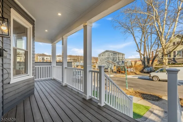 a view of a balcony with wooden floor and fence