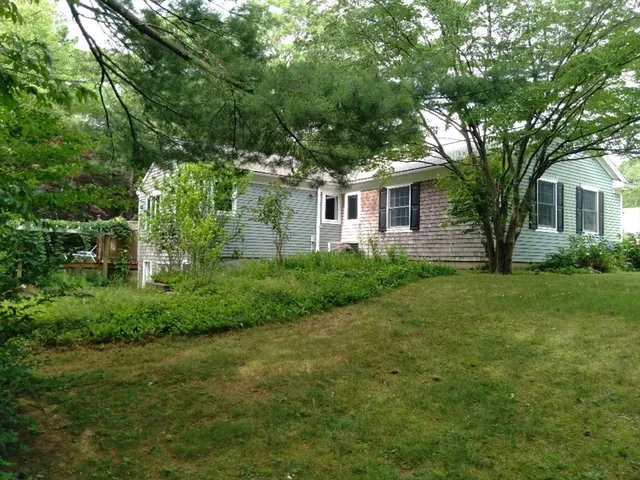 a front view of house with yard and green space