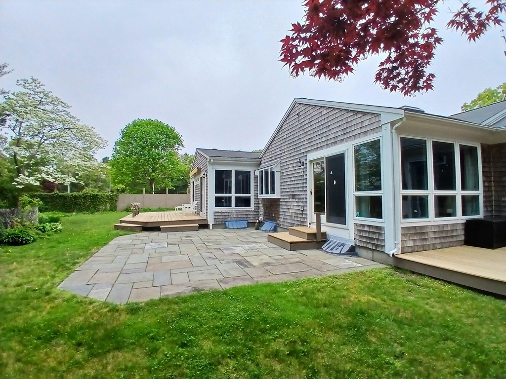 43 Poponessett Road Barnstable, MA 02635 - Photo 18 of 29 a view of a house with sitting area and garden