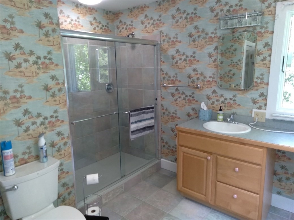 43 Poponessett Road Barnstable, MA 02635 - Photo 23 of 29 a bathroom with a granite countertop sink a toilet and shower