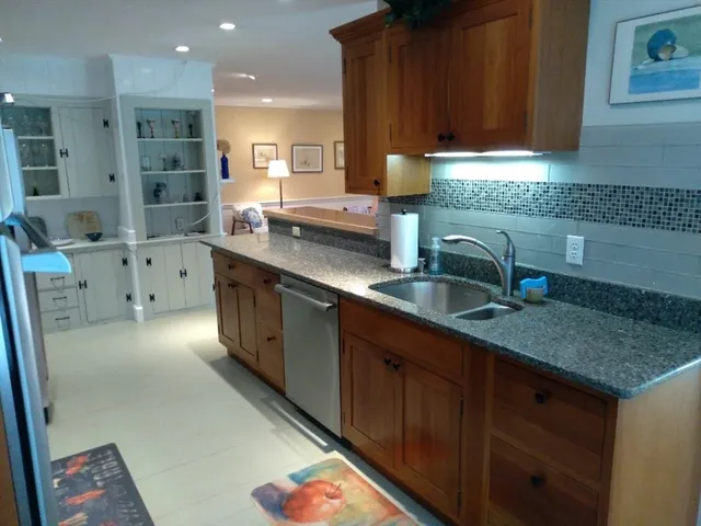 a kitchen with a sink stove and cabinets