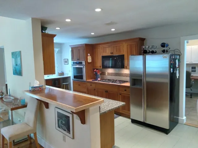 a kitchen with a refrigerator sink and microwave