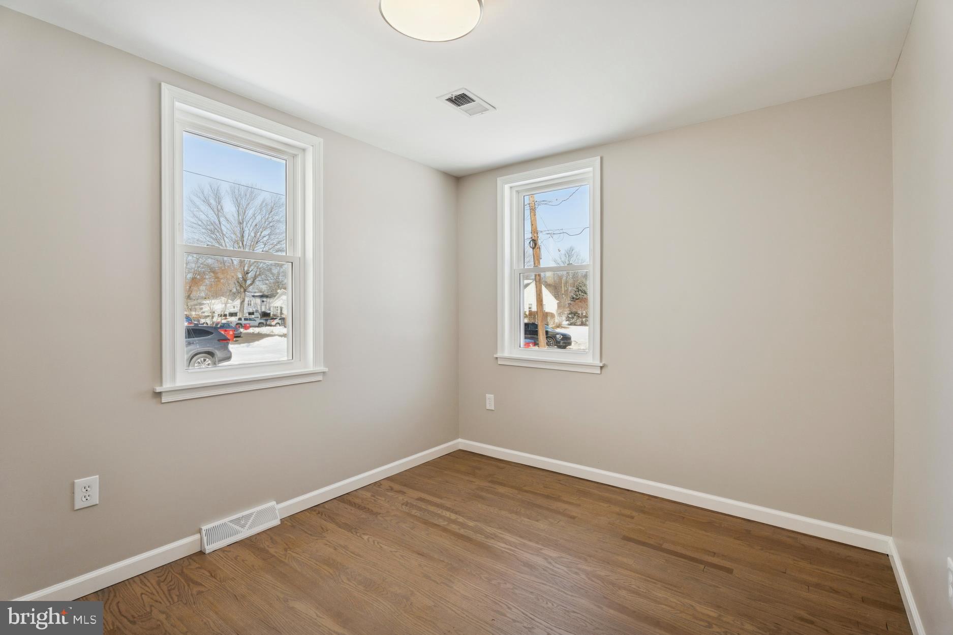 306 Grape Street Warminster, PA 18974 - Photo 15 of 25 a view of an empty room with wooden floor and a window