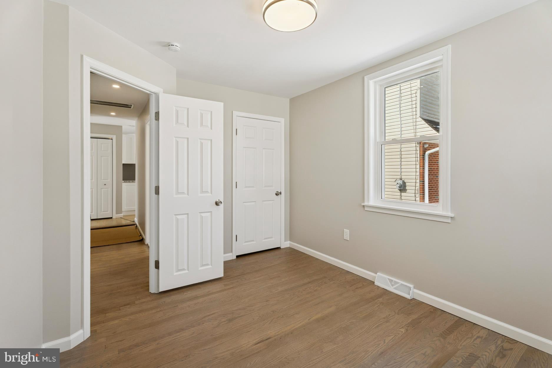 306 Grape Street Warminster, PA 18974 - Photo 16 of 25 an empty room with wooden floor and windows