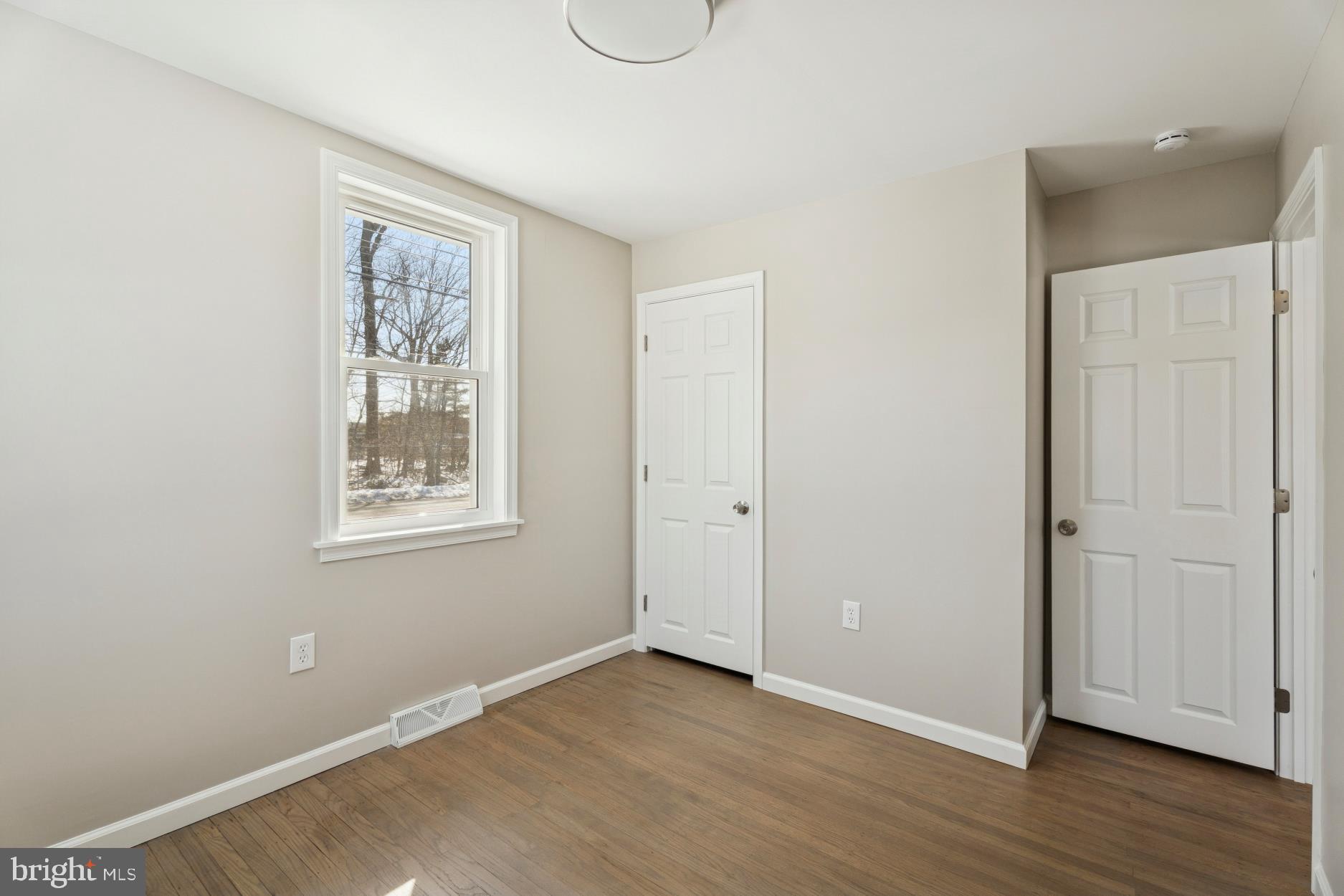306 Grape Street Warminster, PA 18974 - Photo 22 of 25 an empty room with wooden floor and windows