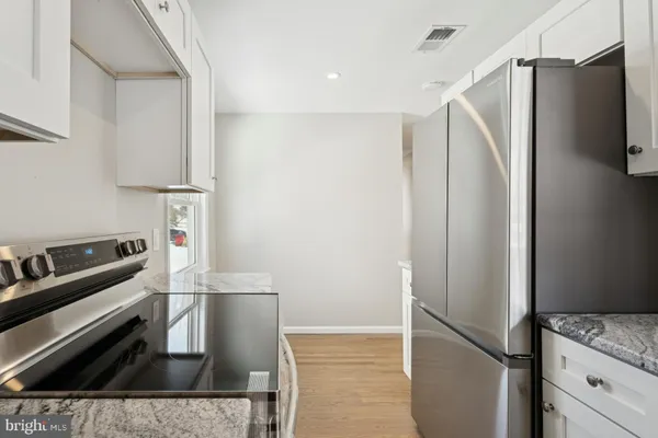 a kitchen with stainless steel appliances a refrigerator and a stove top oven