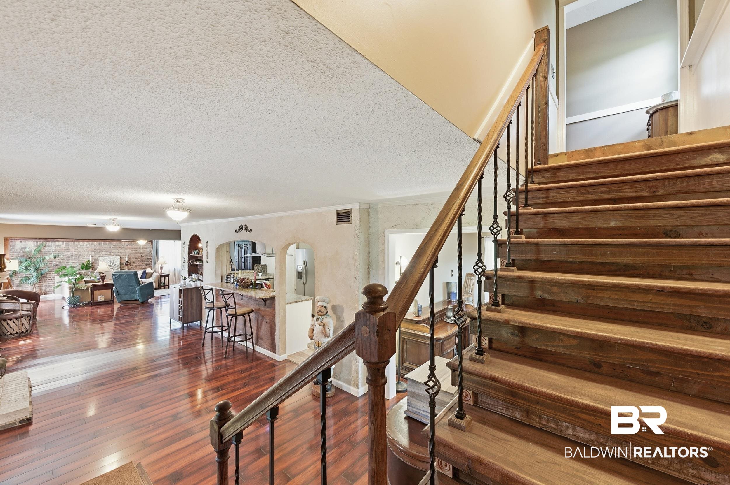51620 Robert White Road Bay Minette, AL 36507 - Photo 38 of 81 Hardwood staircase with wrought iron balusters and a wood handrail