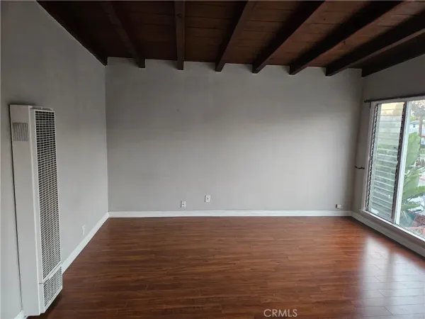 a view of room with window and hardwood floor